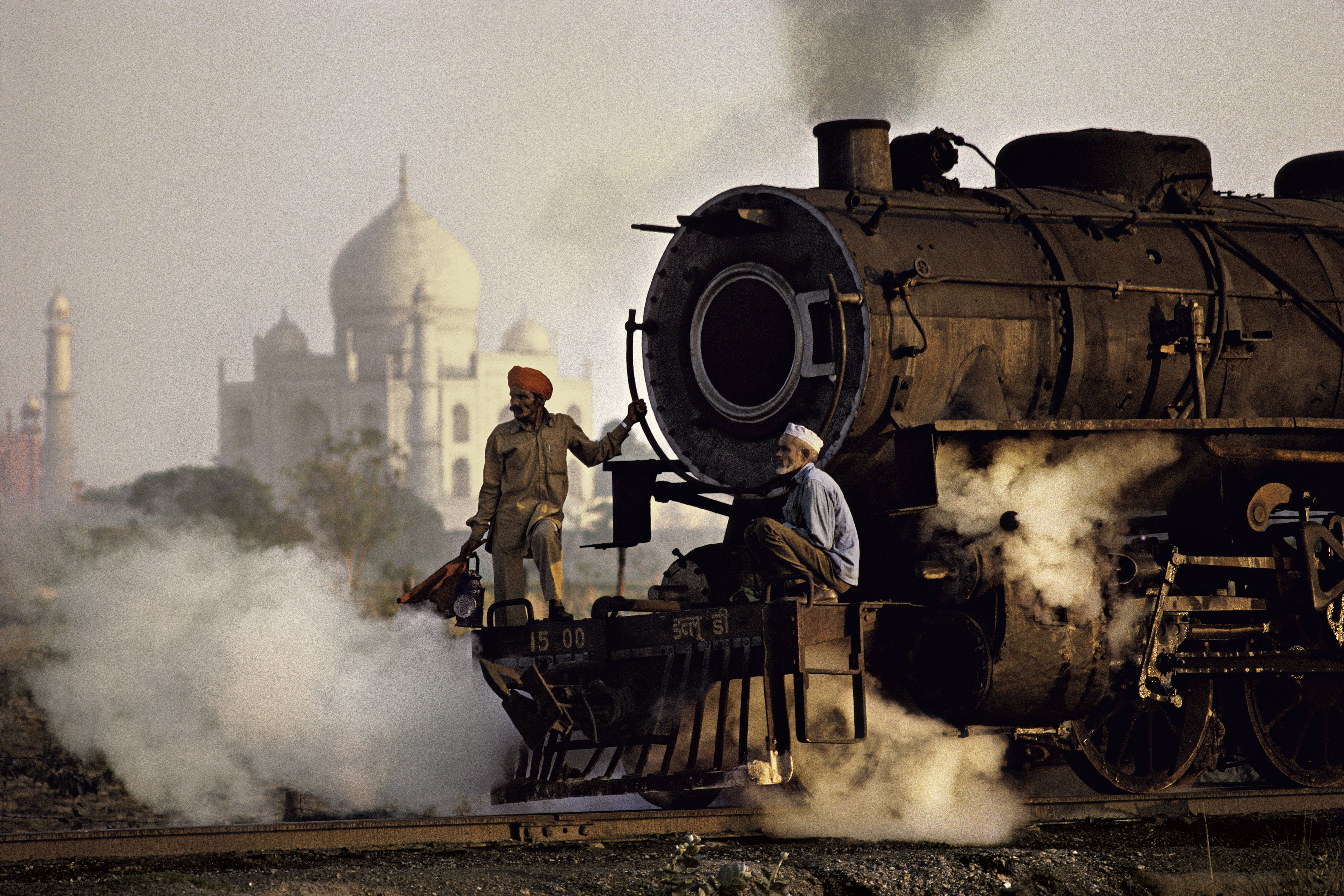 Workers move a steam locomotive at the railway yard in Agra, near Taj Mahal, Pradesh, India, 1983